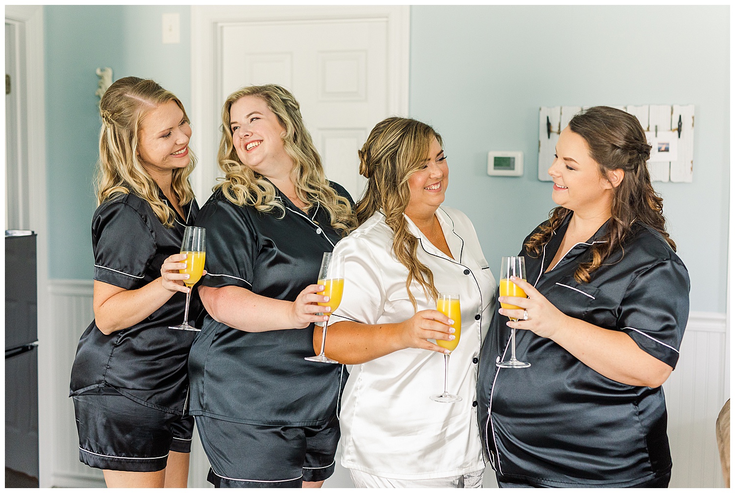 bride and bridesmaids holding champagne