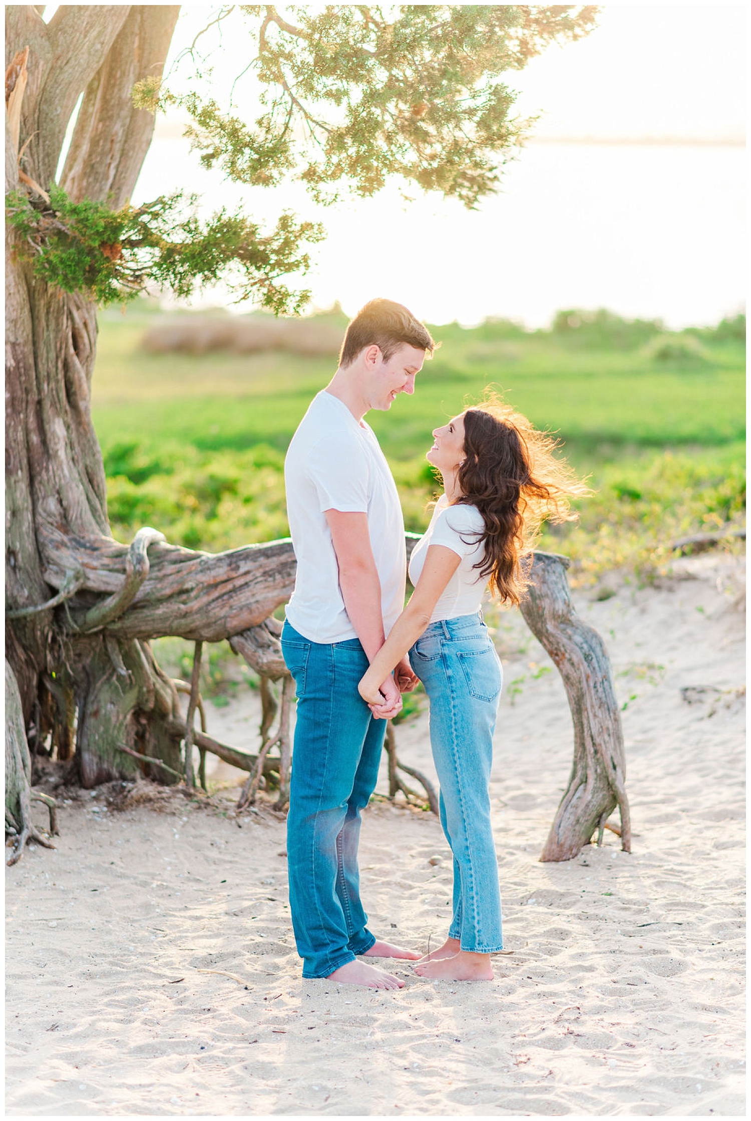 couple standing together at beach engagement session in North Carolina