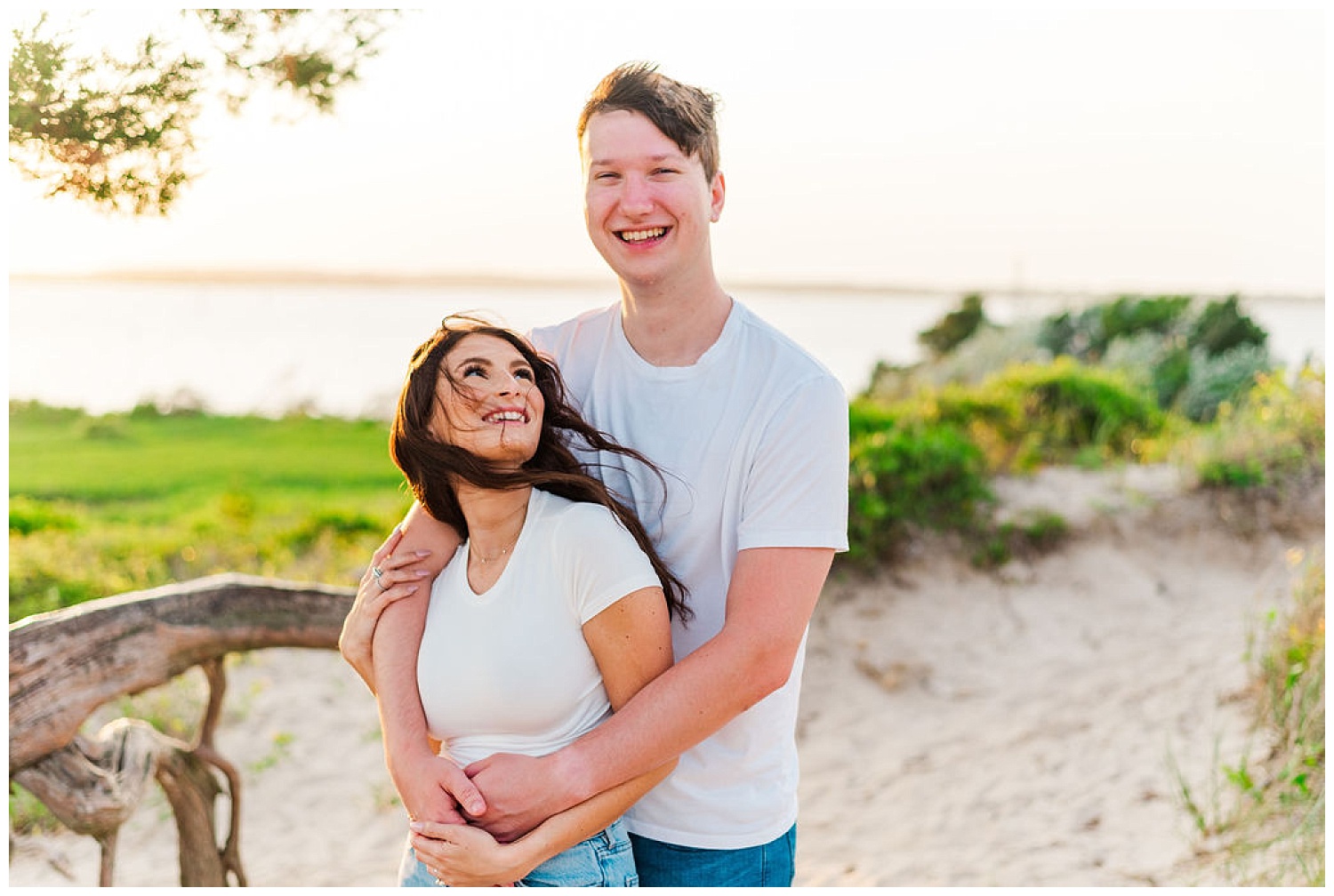 couple hugging at beach engagement session