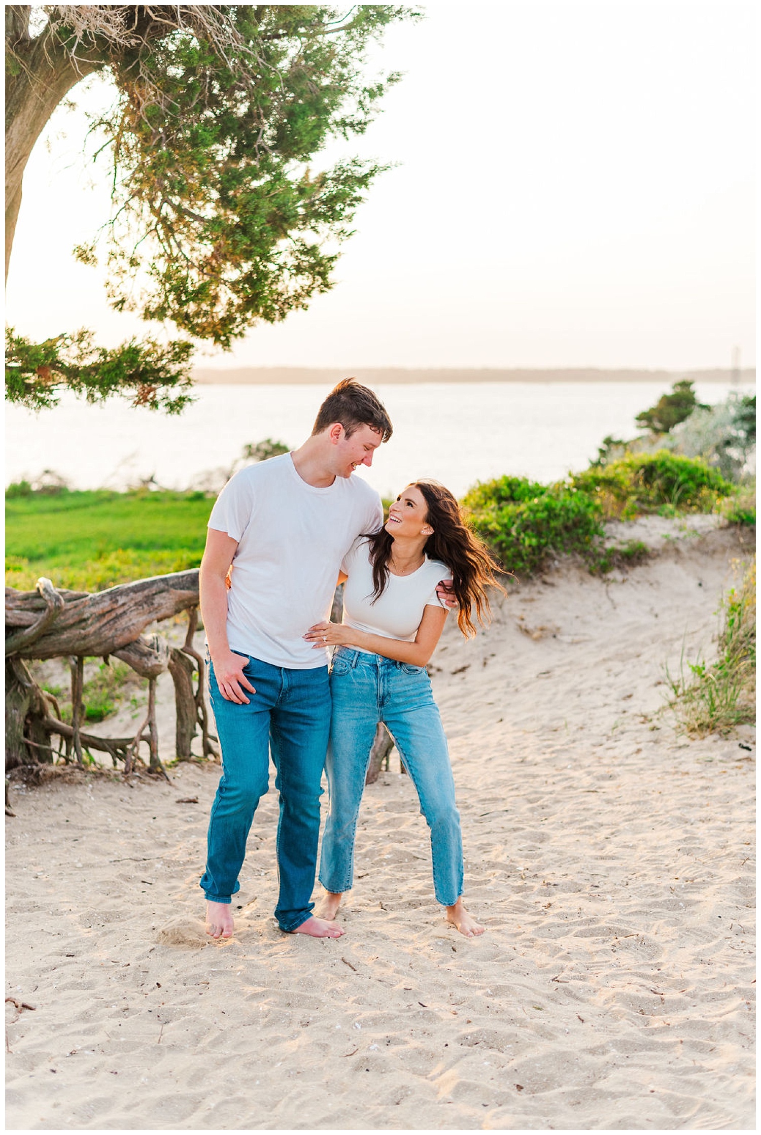 couple walking and laughing at beach engagement session