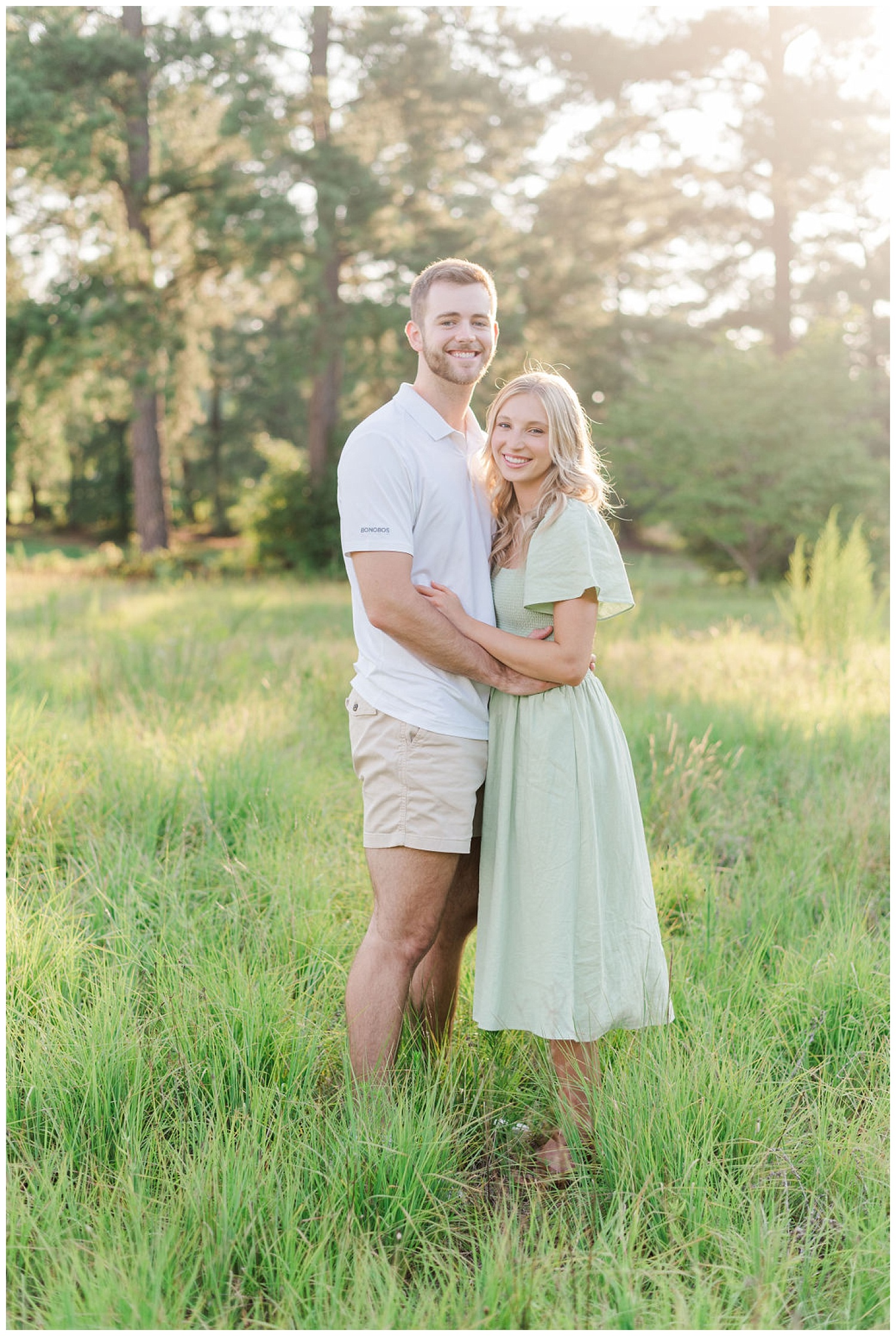 engaged couple posing in a field at Lake Gaston, NC