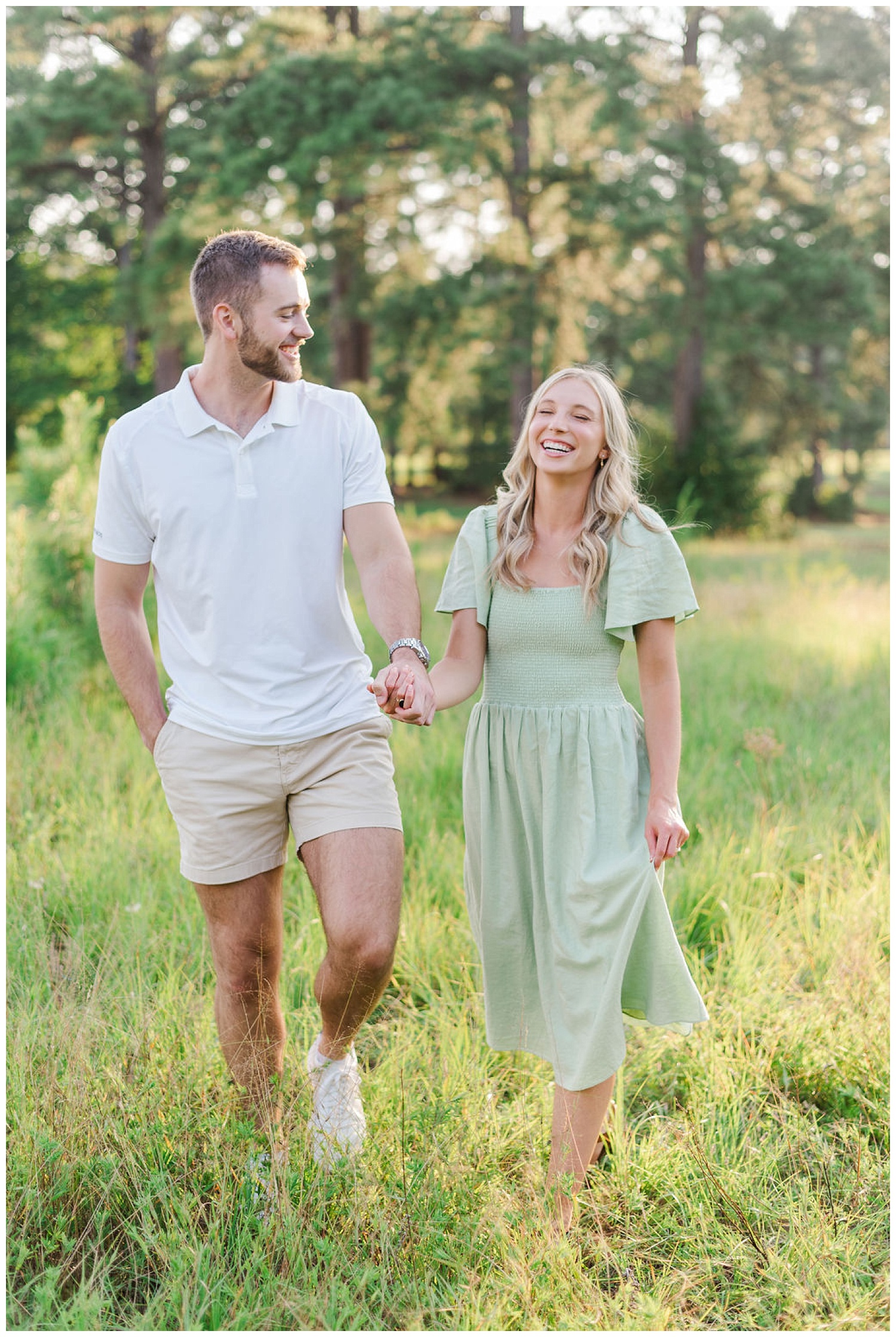 couple laughing together at engagement session at Lake Gaston