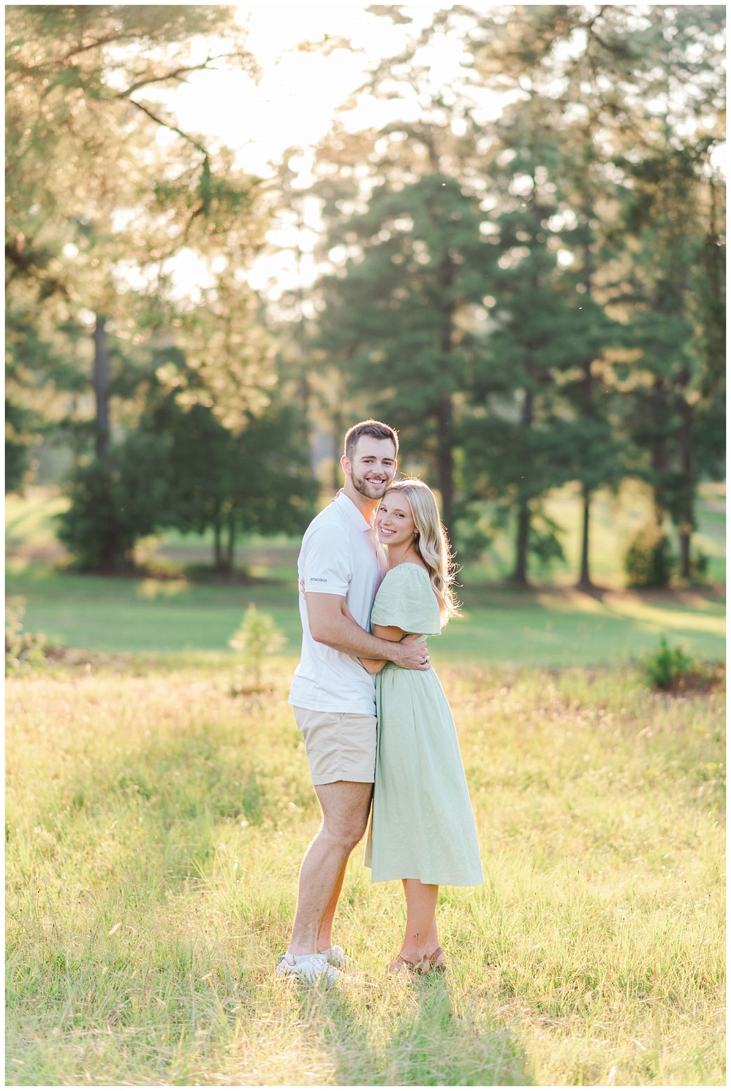 engaged couple smiling in a field in North Carolina