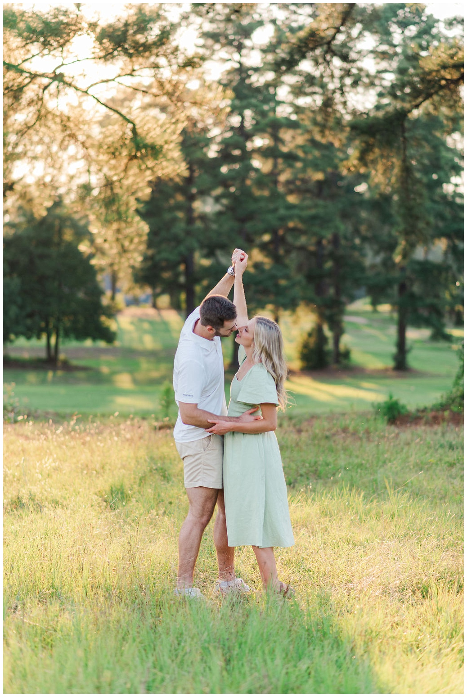 engaged couple dancing together in a field in North Carolina