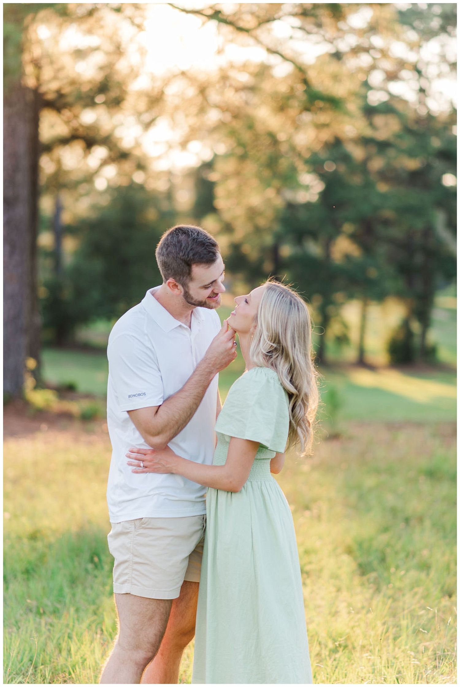 couple smiling at each other during Lake Gaston engagement session