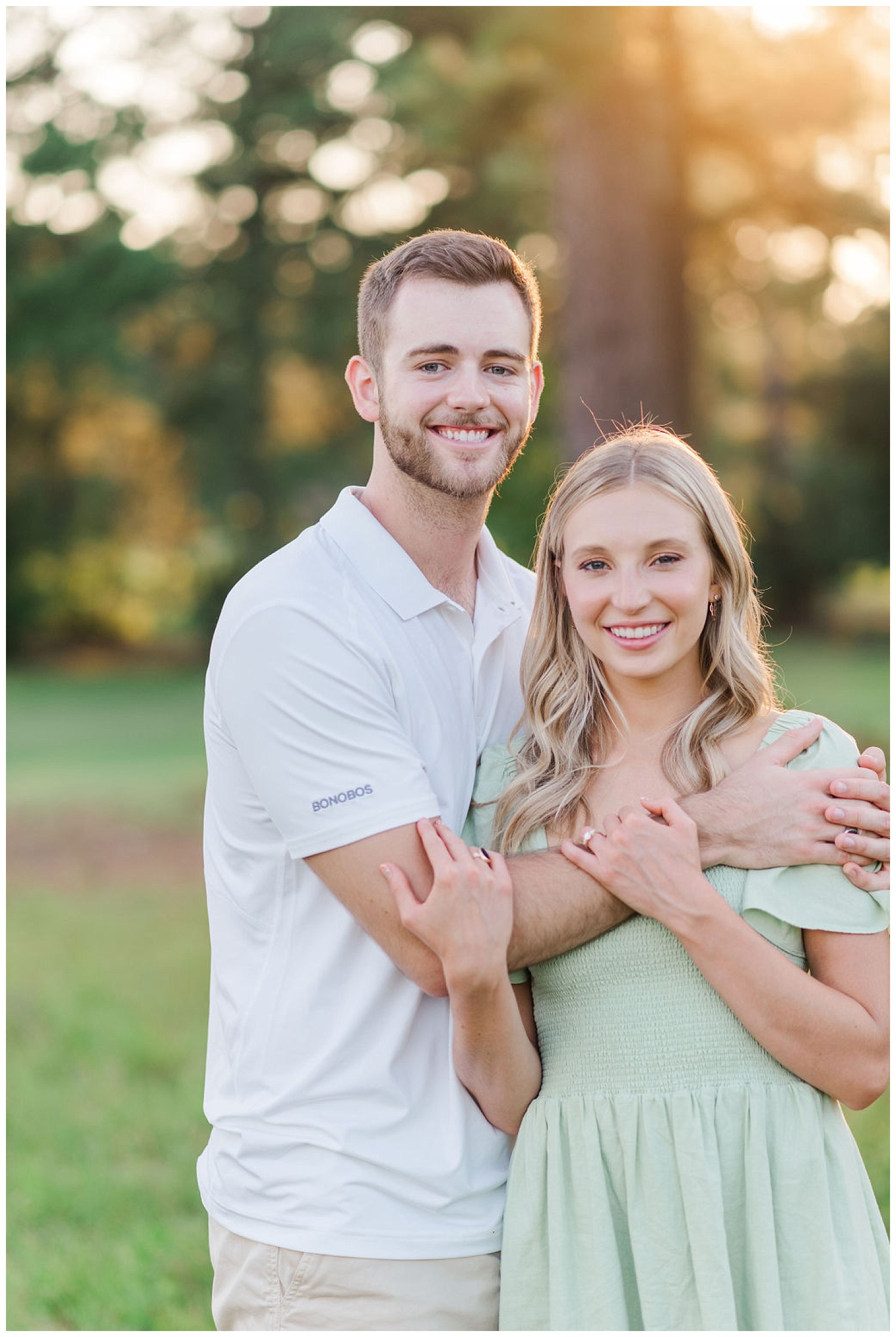 couple smiling at the camera for engagement photos 