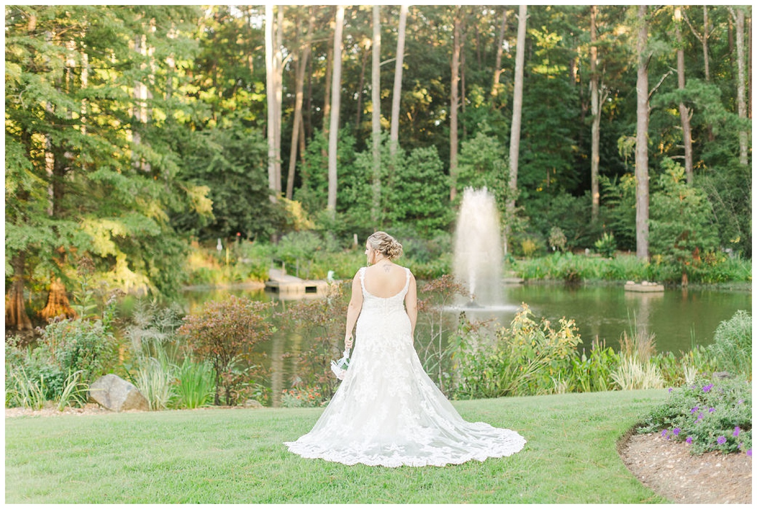 bride facing the pond showing the back of her dress