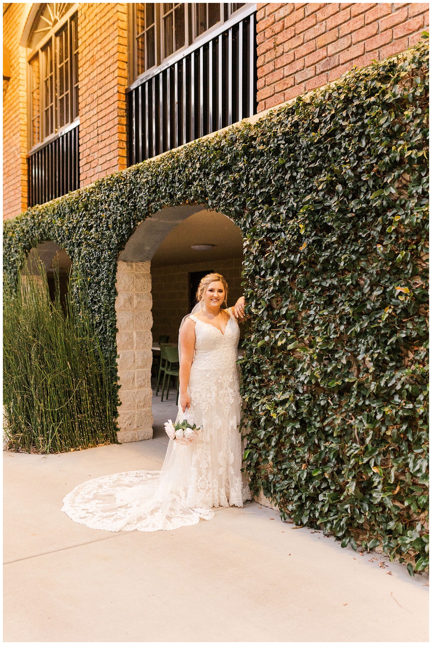 bride standing against a greenery wall at bridal session in North Carolina