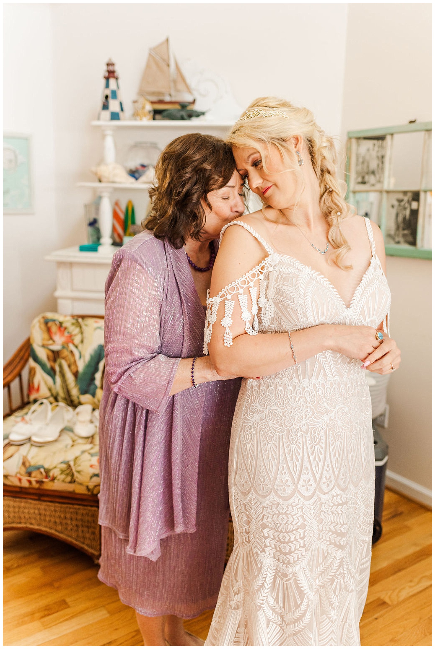 bride and her mom touching foreheads while getting ready