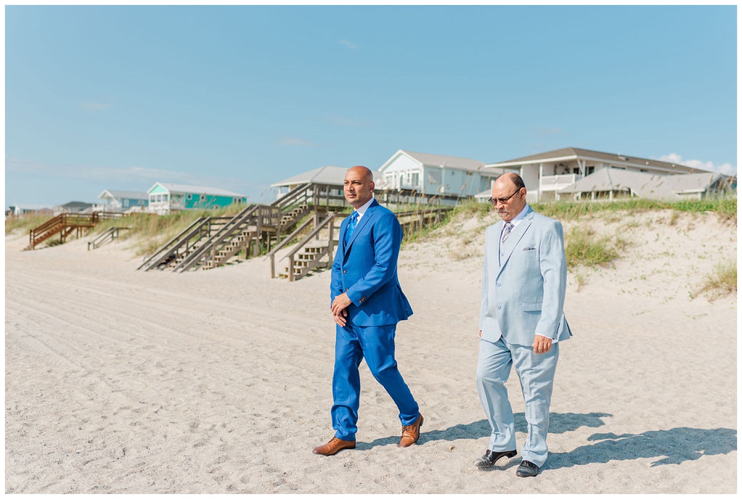 groom and groom's dad walking down the beach for the ceremony