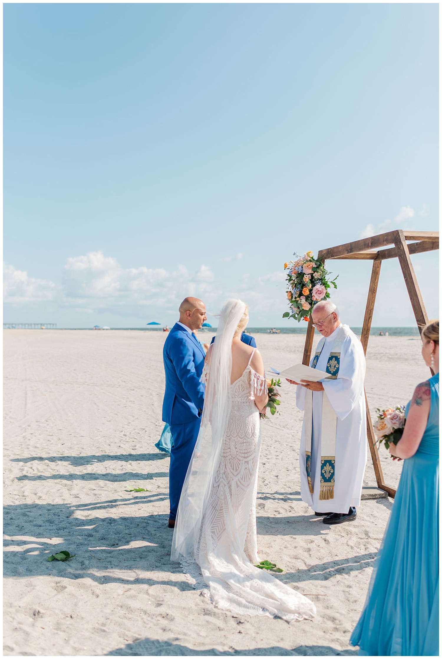 bride and groom standing together at ceremony site at Carolina Beach