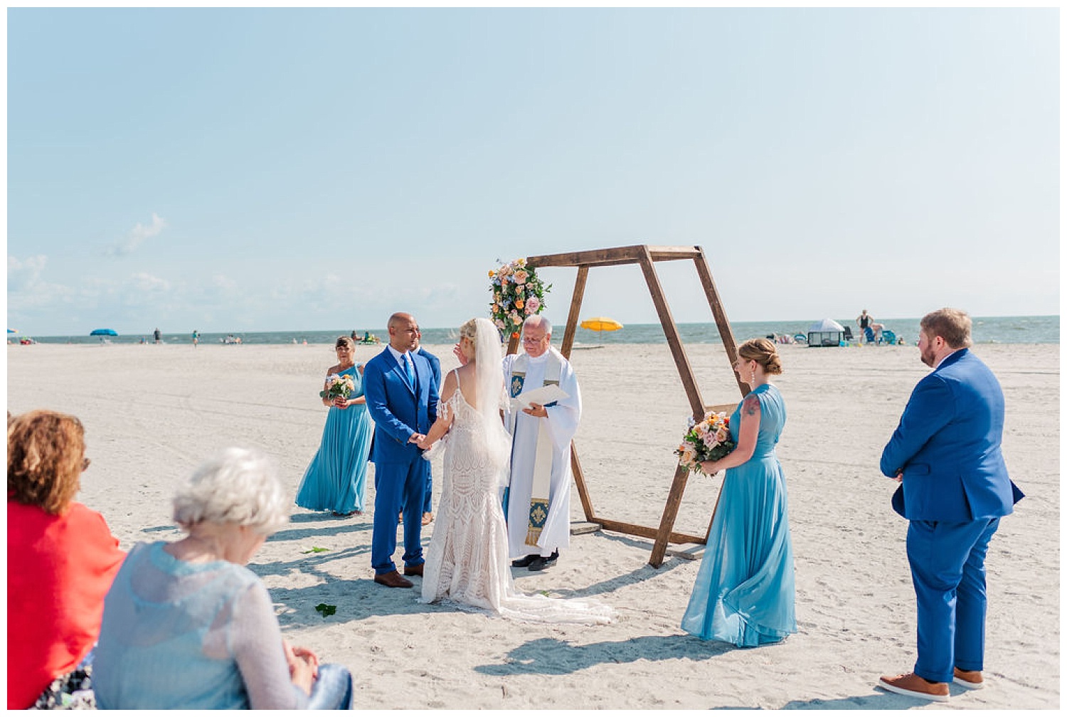 bride and groom holding hands at ceremony site at Carolina Beach