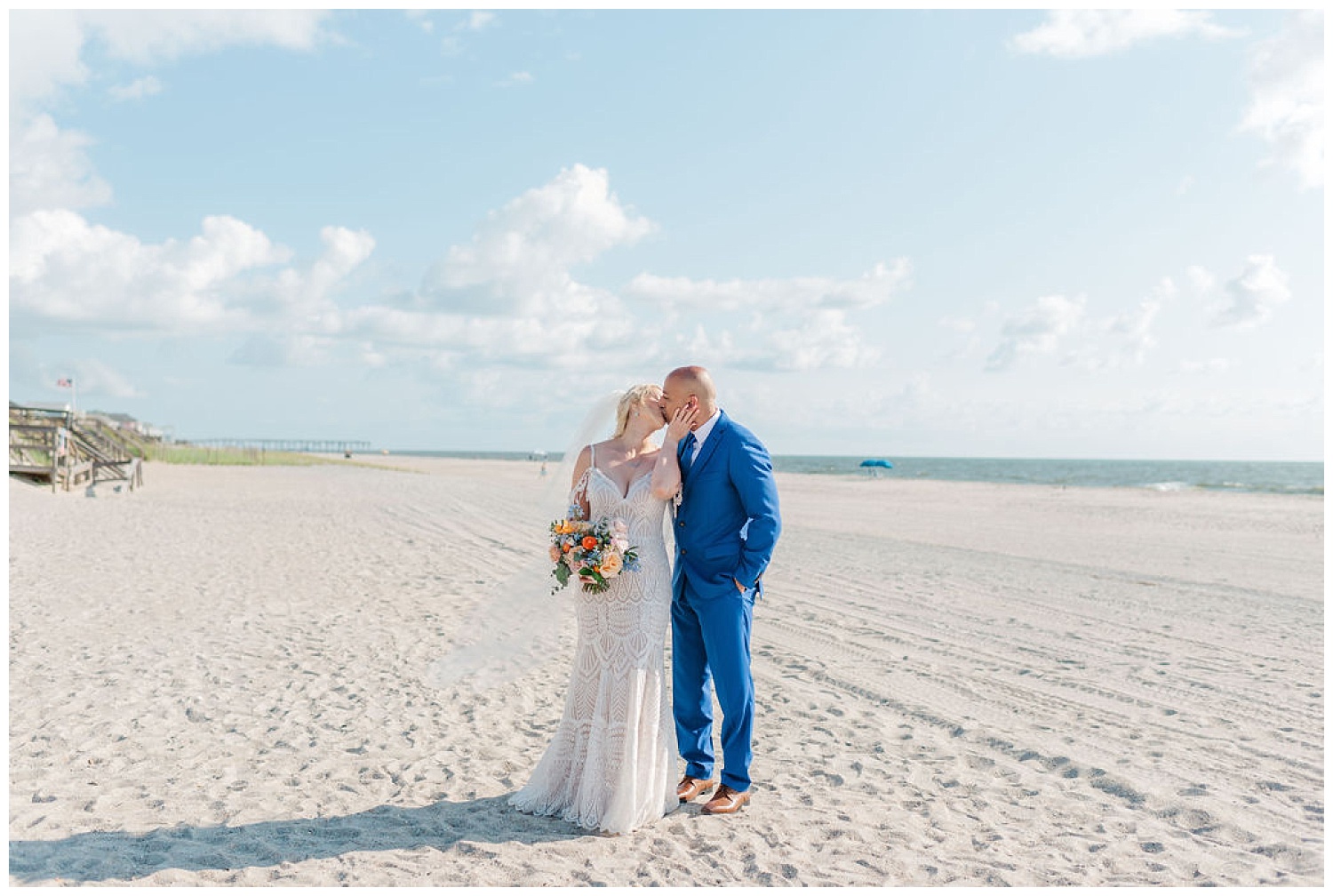 bride and groom kissing on the beach for couples portrairs