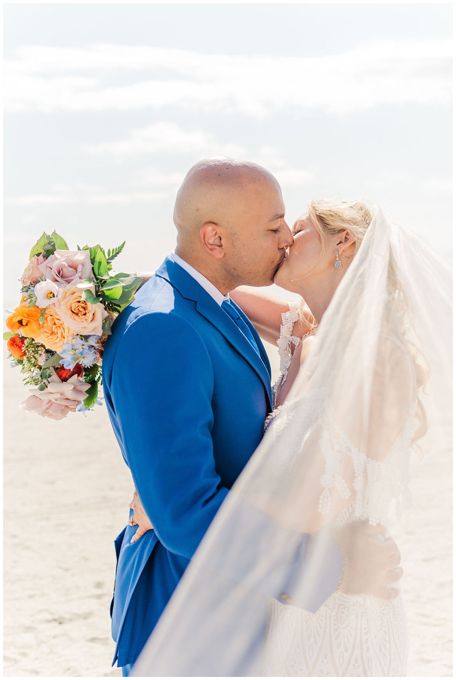 bride and groom kissing on the beach in North Carolina