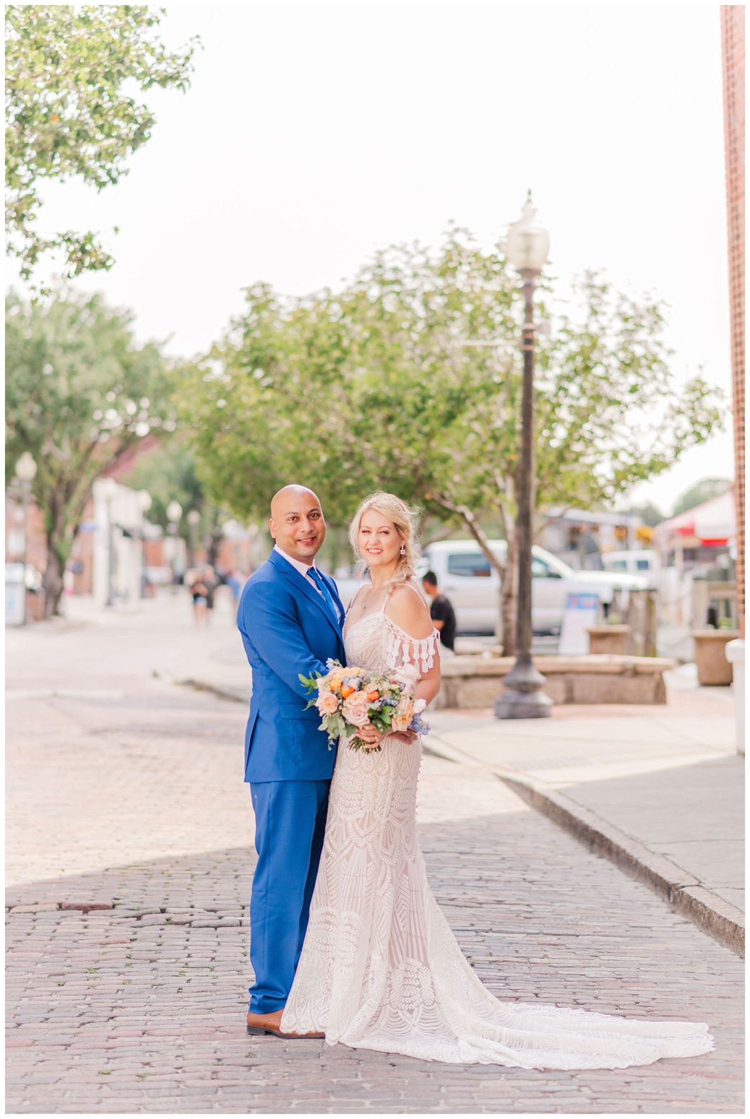 bride and groom standing on the street in downtown Wilmington
