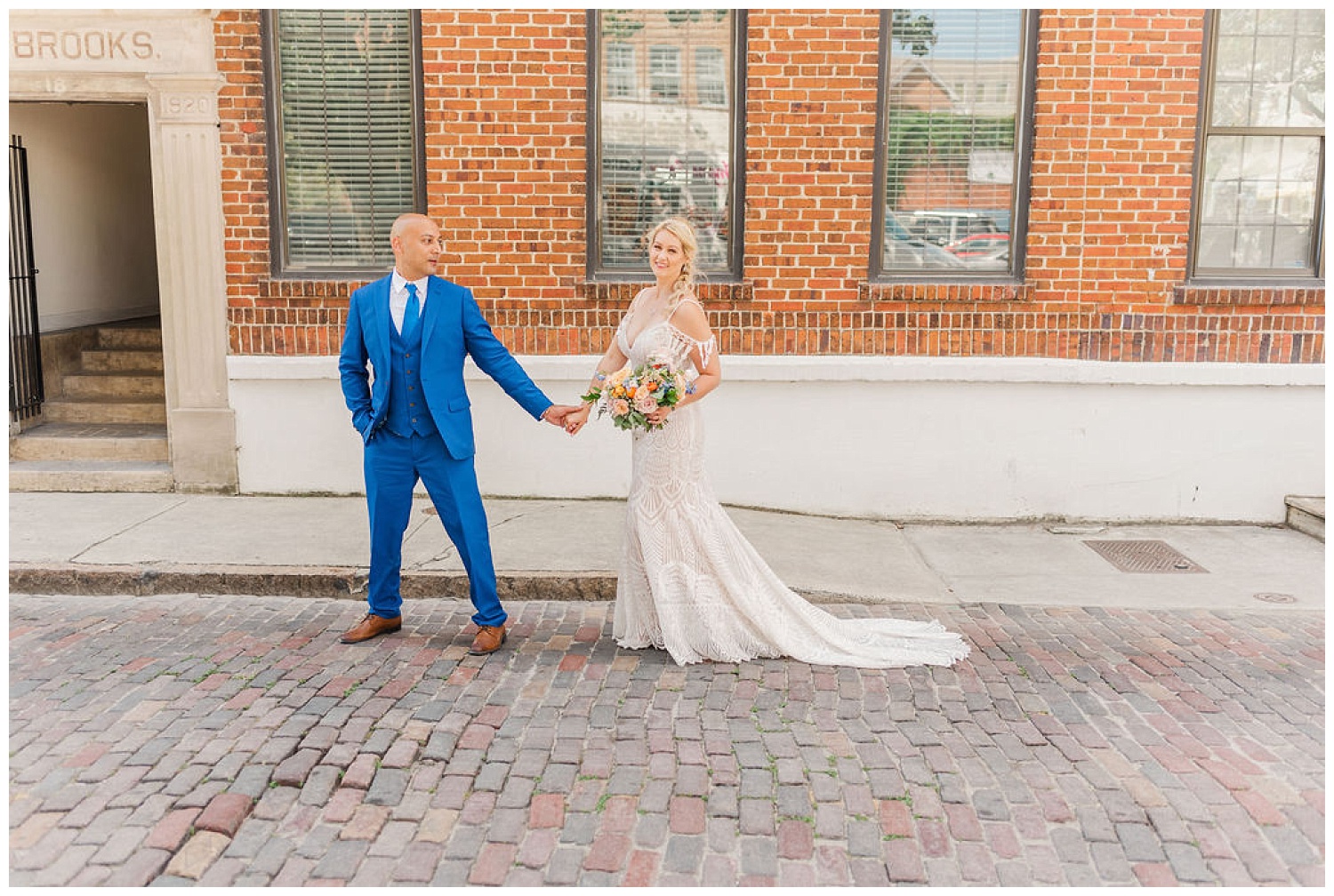 bride and groom walking together on the street in downtown Wilmington