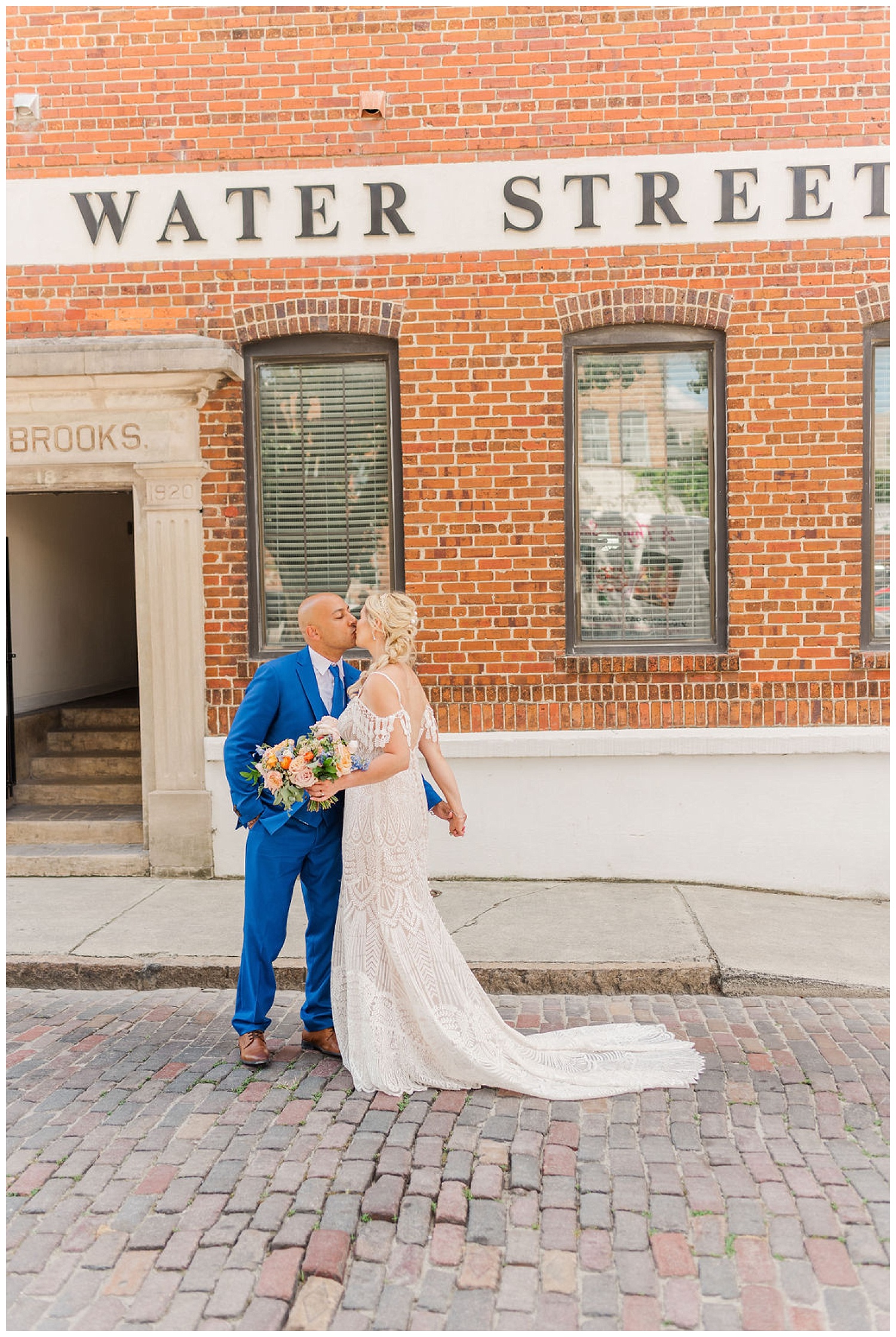 bride and groom kissing on Water Street in downtown Wilmington