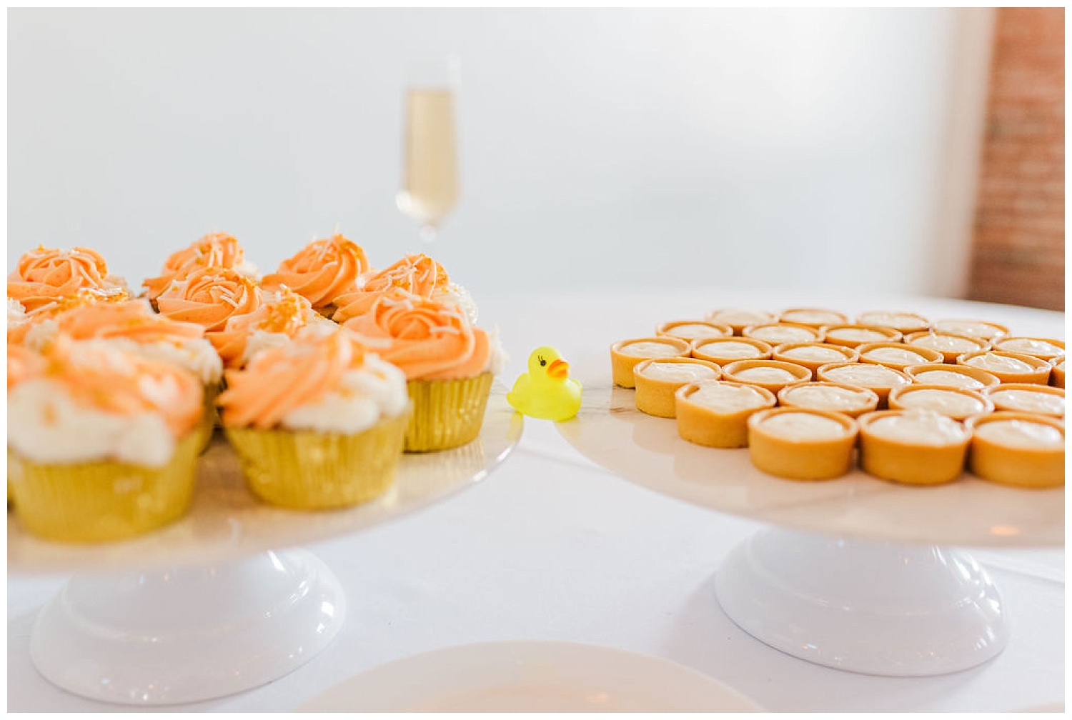 a little yellow rubber duck sitting next to desserts at the River Room