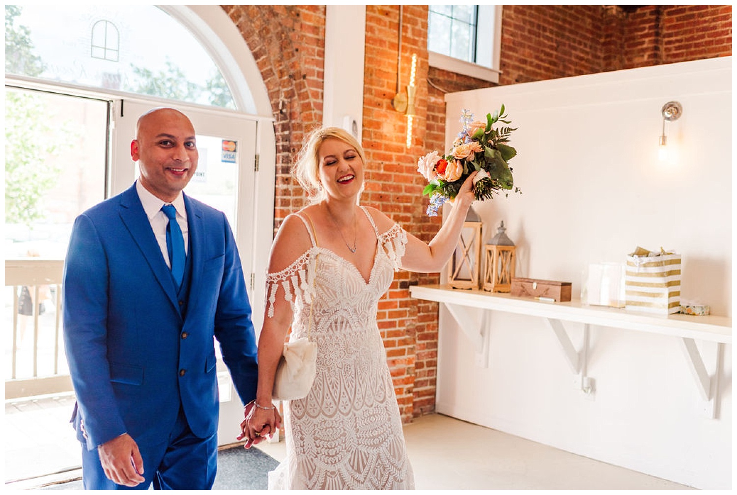 bride and groom walking into their reception at the River Room in Wilmington