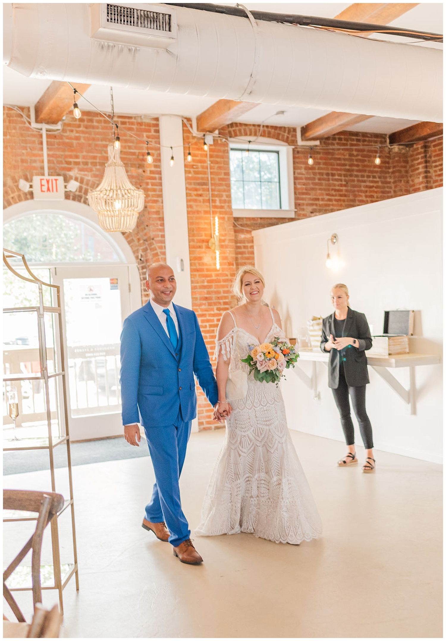 bride and groom walking into their reception at the River Room in Wilmington