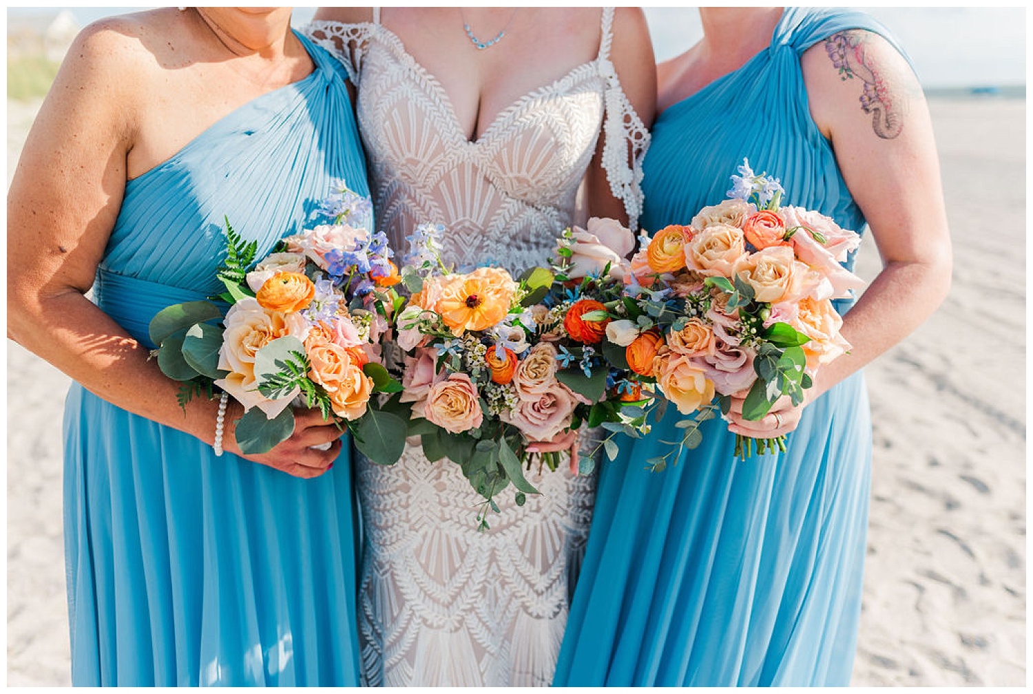close up of bride and bridesmaids flowers on the beach