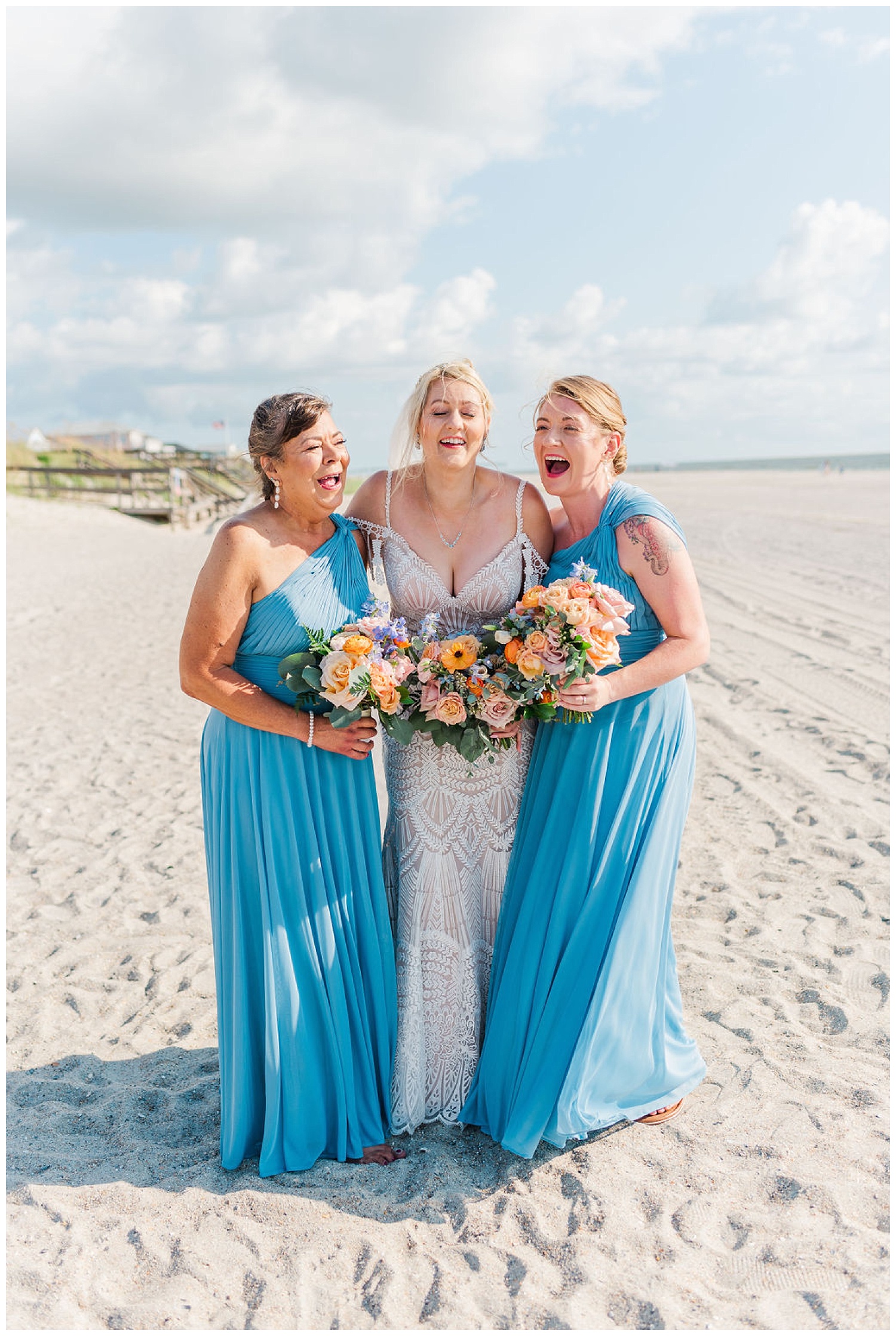 bride posing with her bridesmaids on the beach in North Carolina