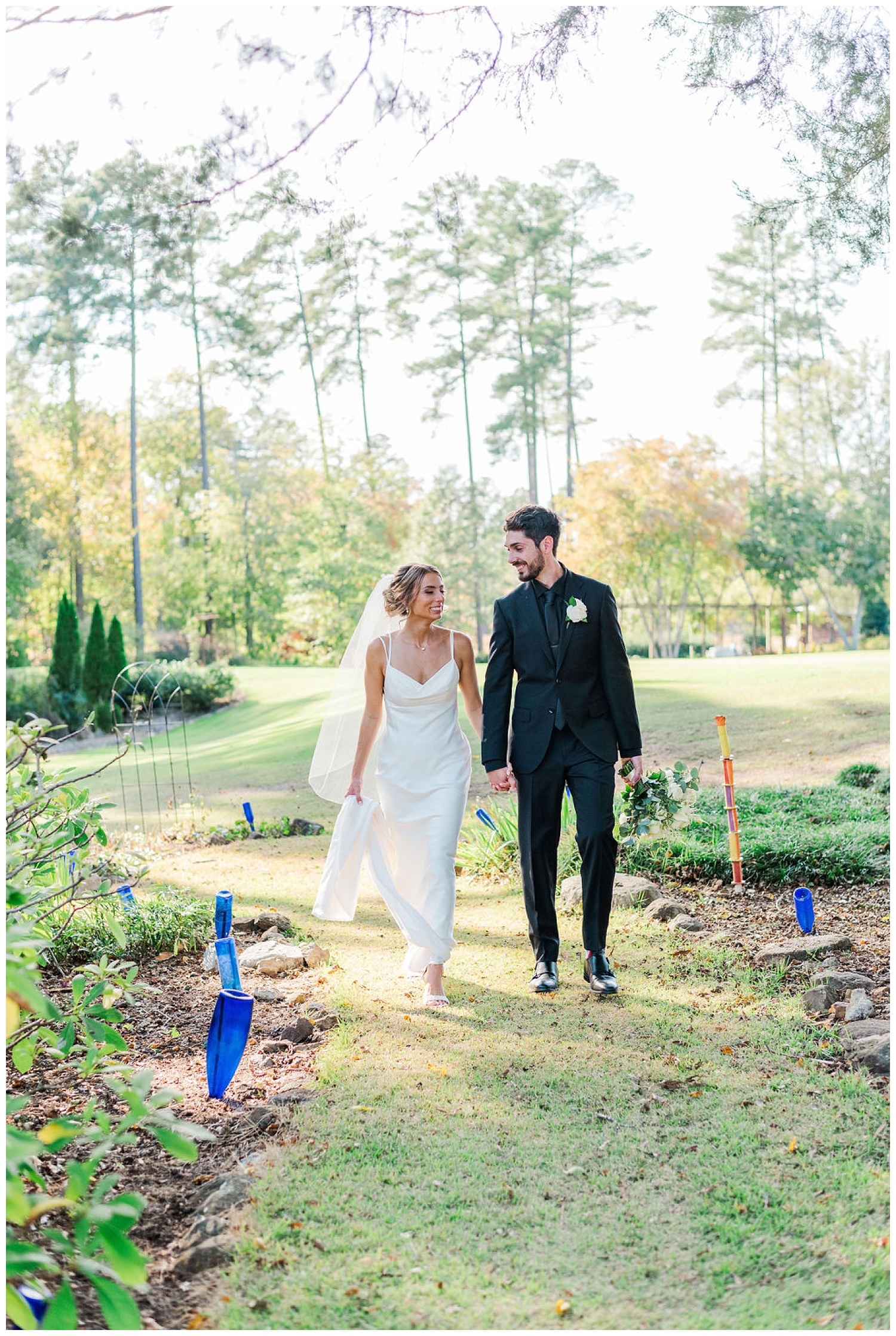 bride and groom walking on a path in Chapel Hill