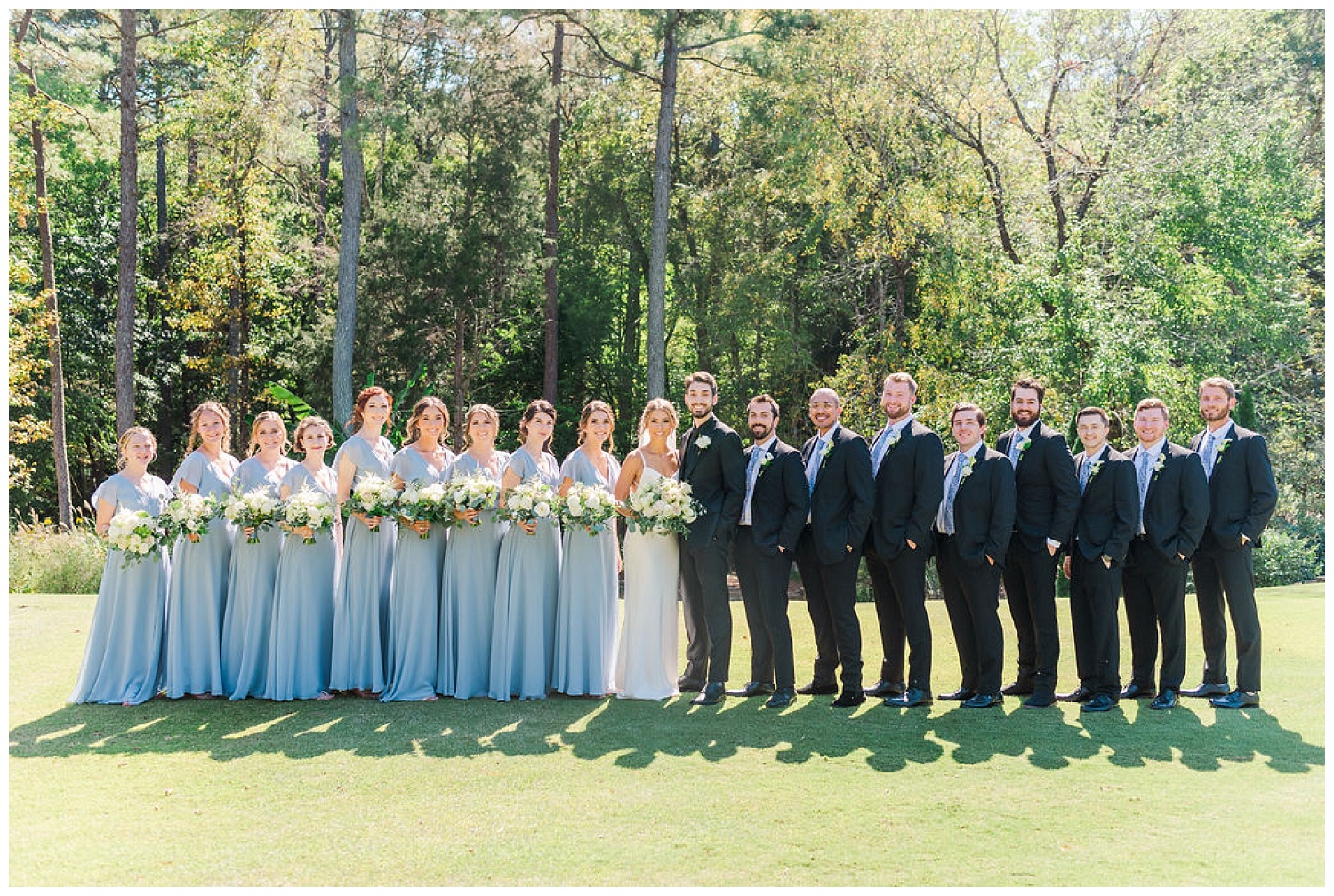 full bridal party posing at Chapel Hill Carriage House