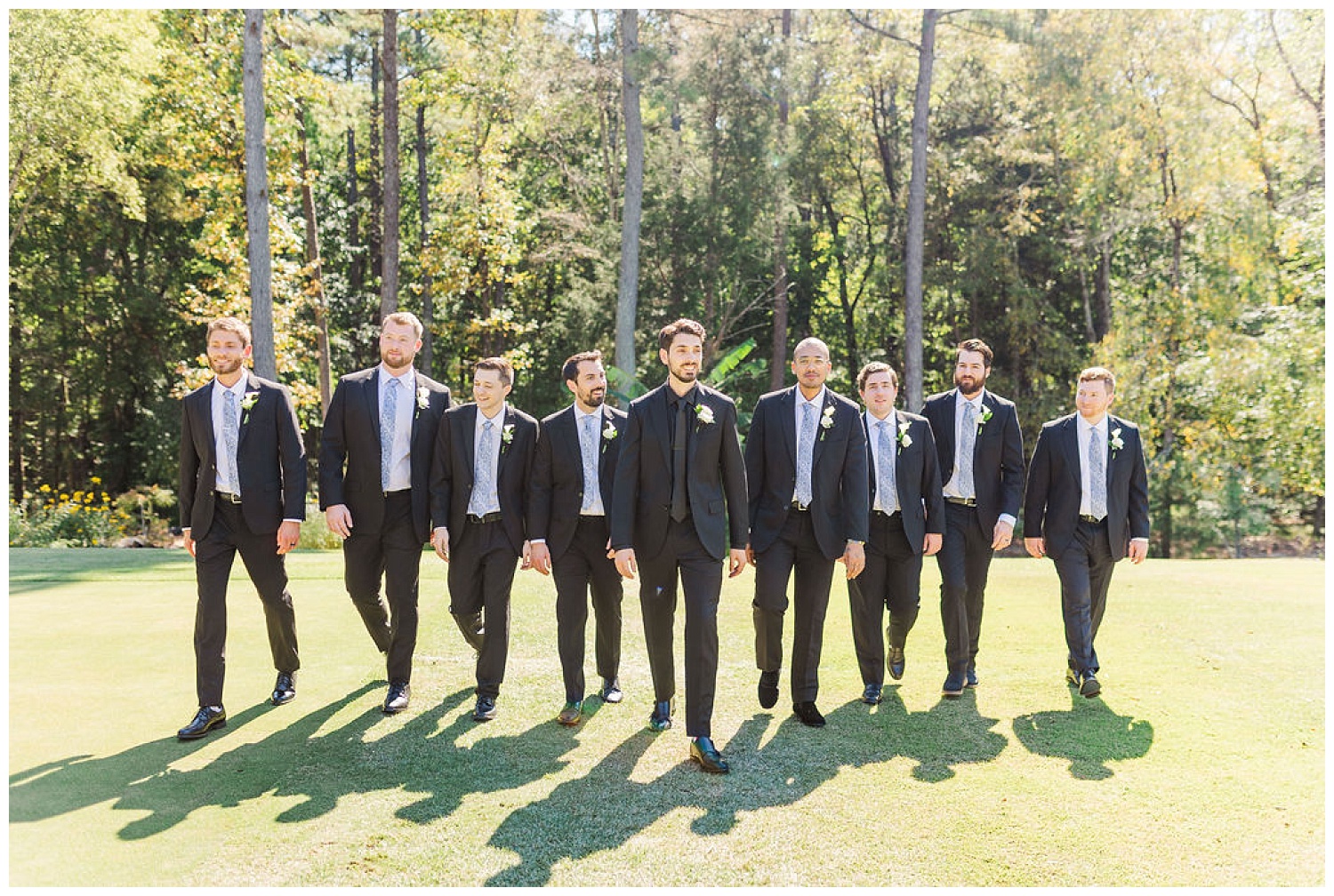 groom and groomsmen walking together at Chapel Hill Carriage House