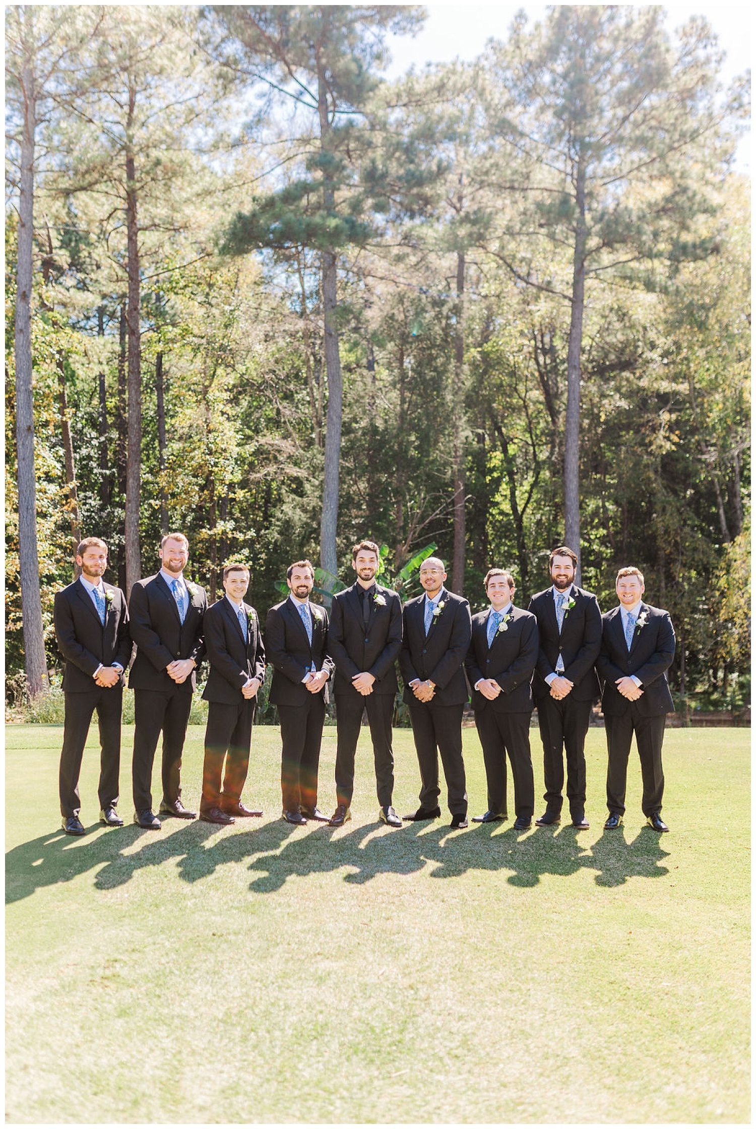 groom and groomsmen posing together at Chapel Hill Carriage House