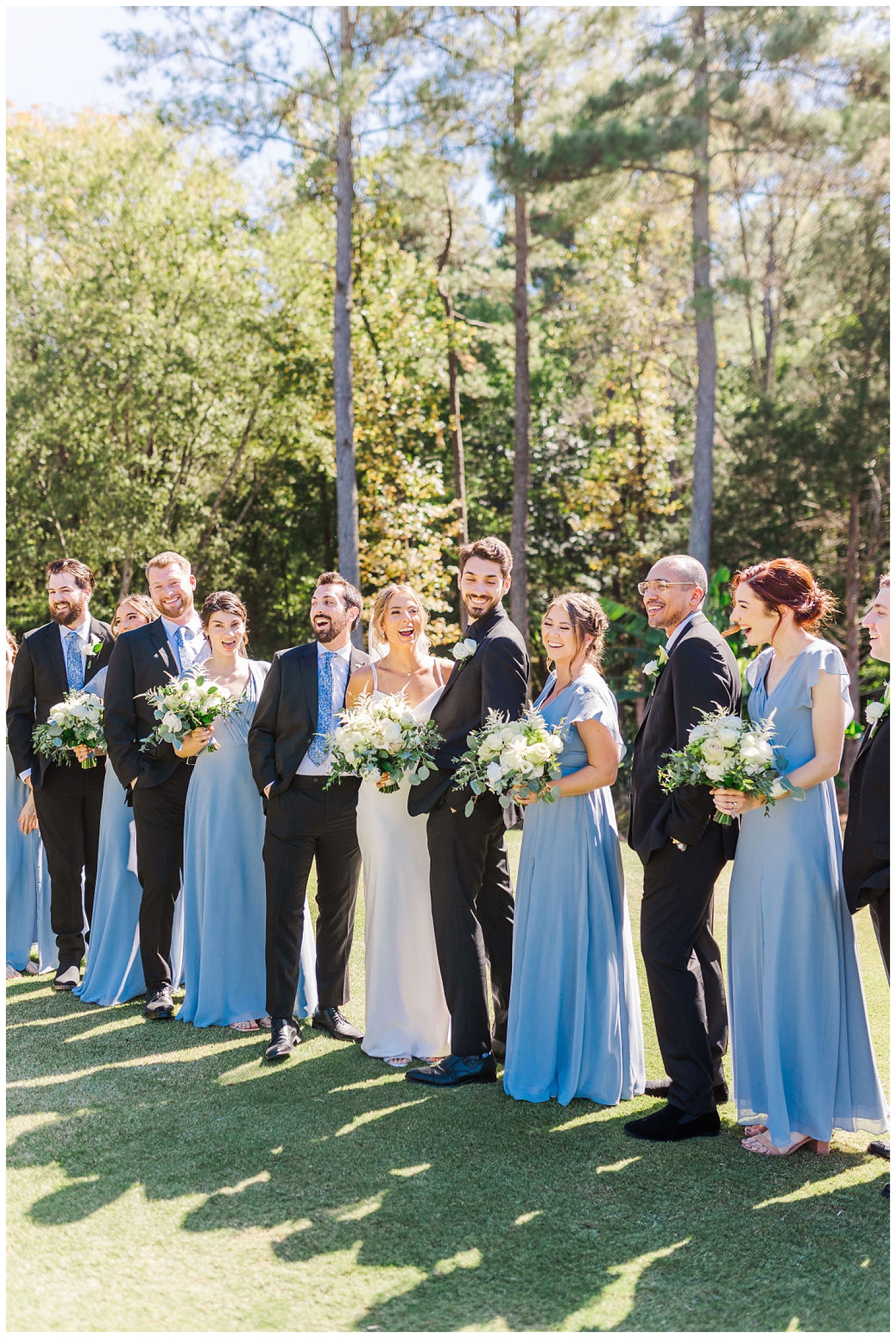 full bridal party laughing at Chapel Hill Carriage House