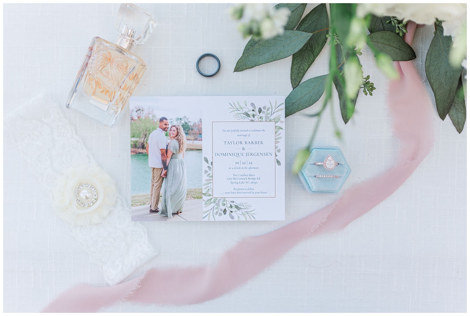 flat lay wedding details next to a pink ribbon