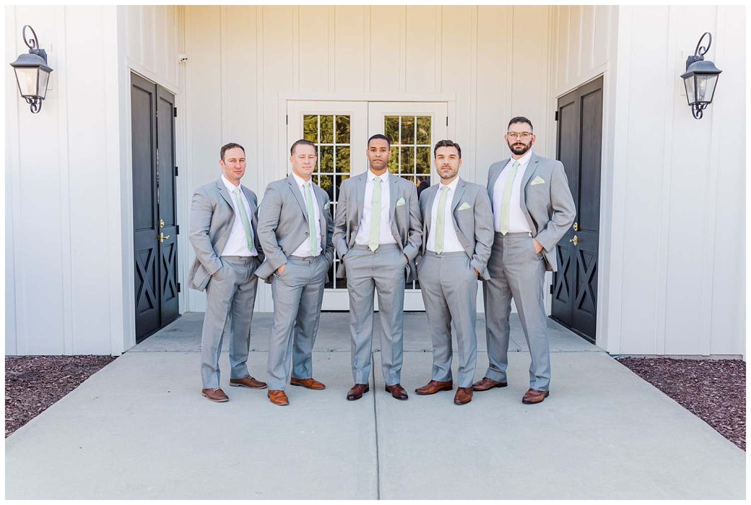 groomsmen posing outside The Carolina Barn