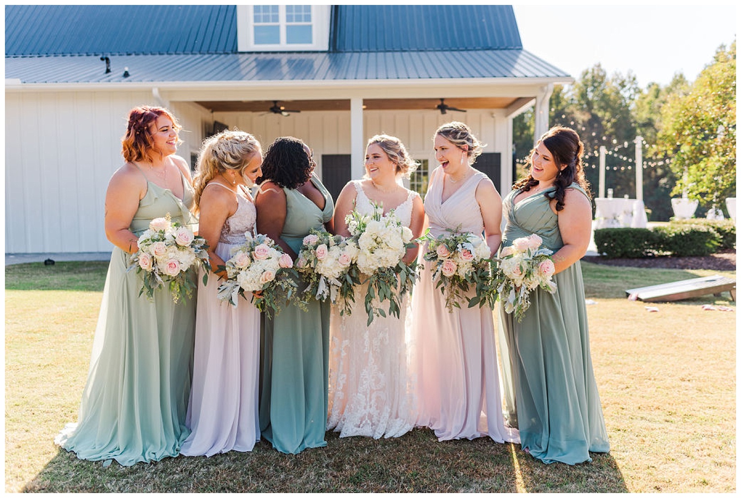 bride and bridesmaids posing at The Carolina Barn