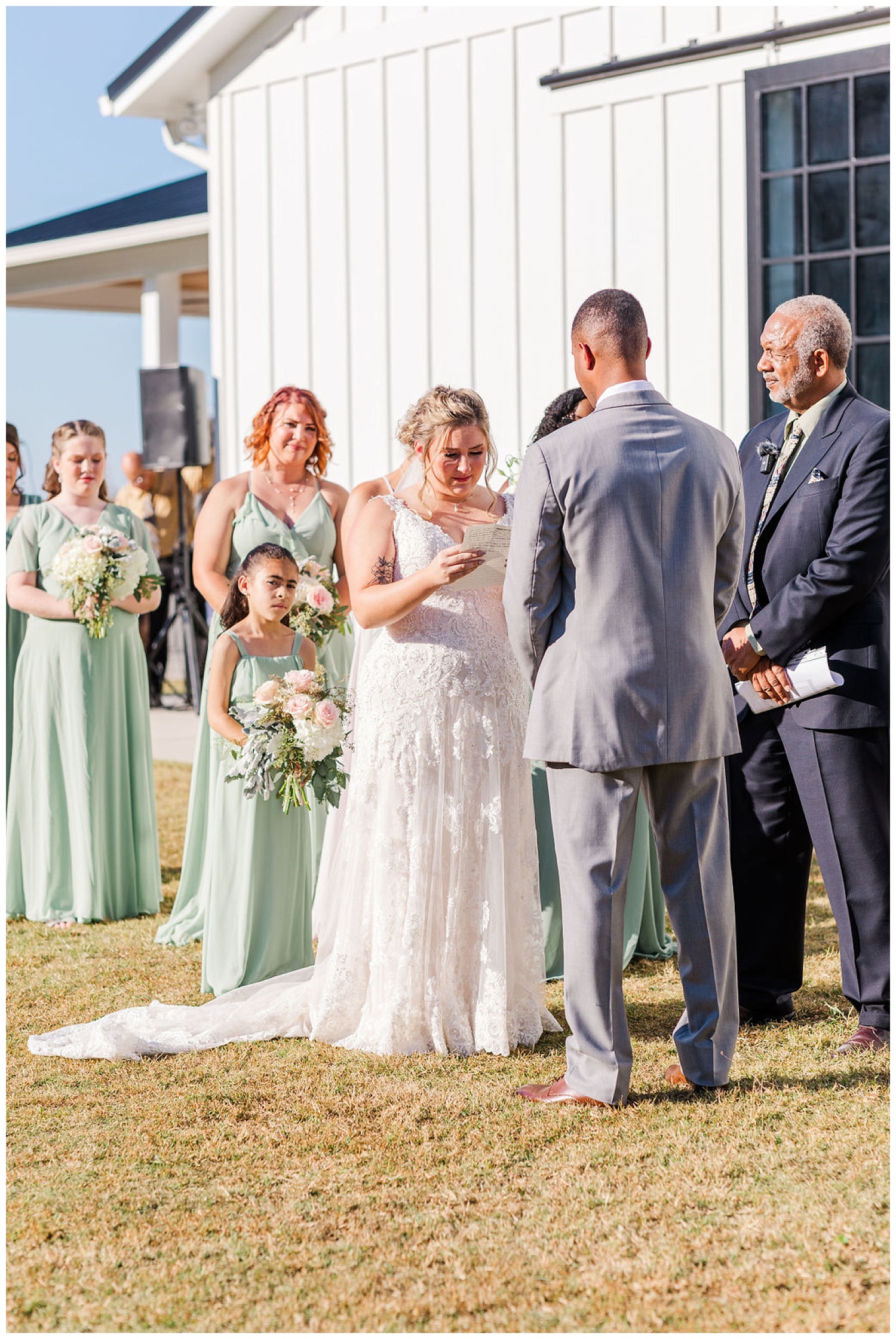 bride's reading vows at ceremony at The Carolina Barn
