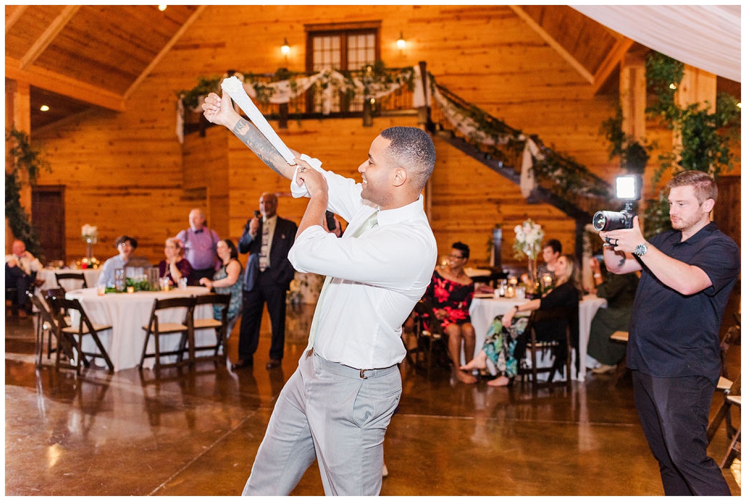groom tossing garter at wedding reception in North Carolina