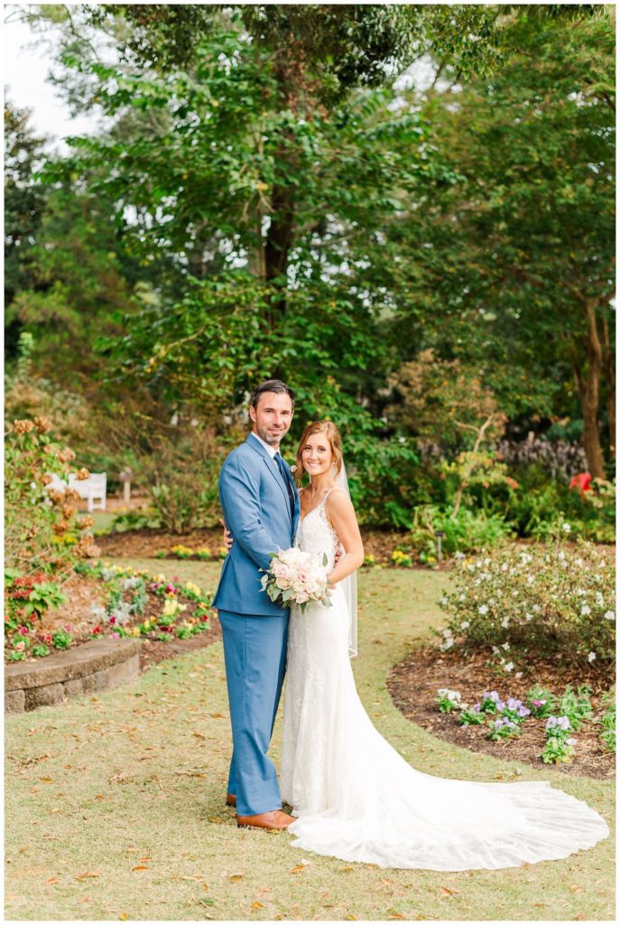 bride and groom posing at New Hanover County Arboretum in Wilmington