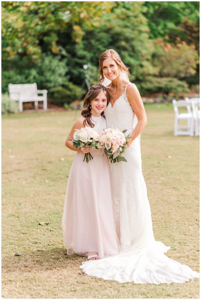 bride posing with daughter after wedding ceremony