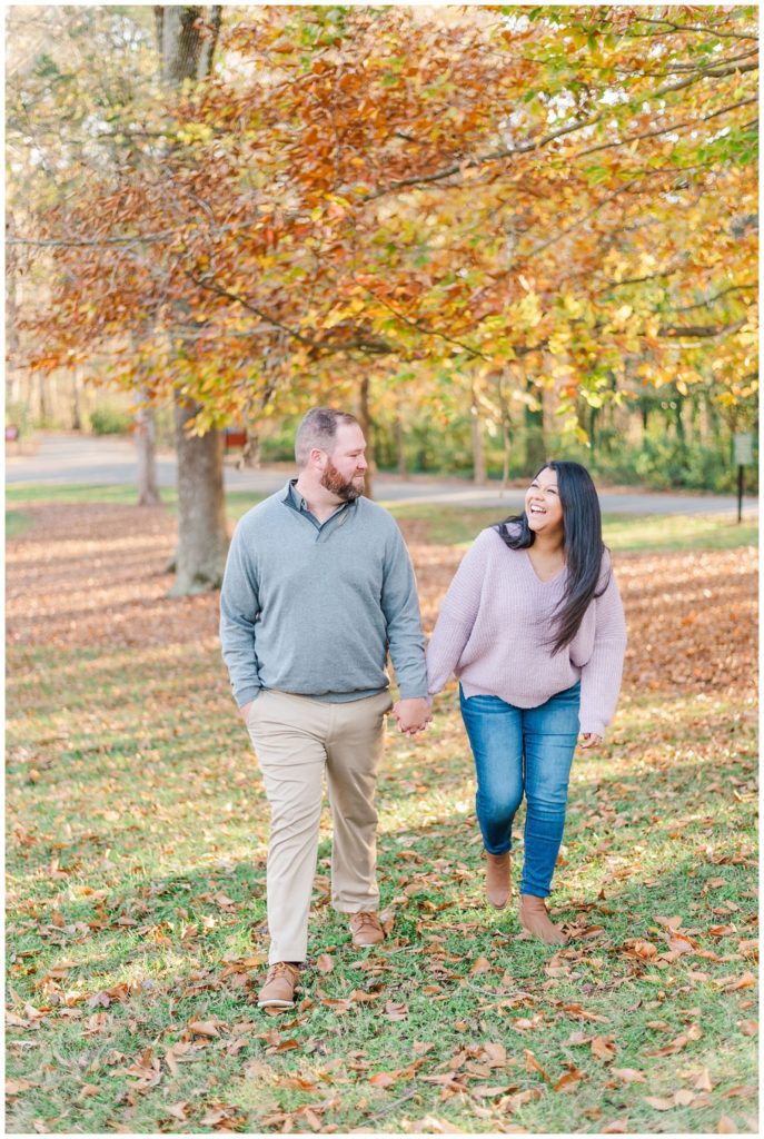 couple walking in front of yellow and orange trees in North Carolina