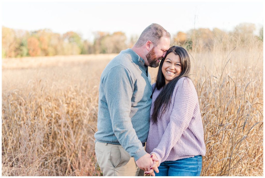 couple laughing at fall engagement session at Reynolda estate