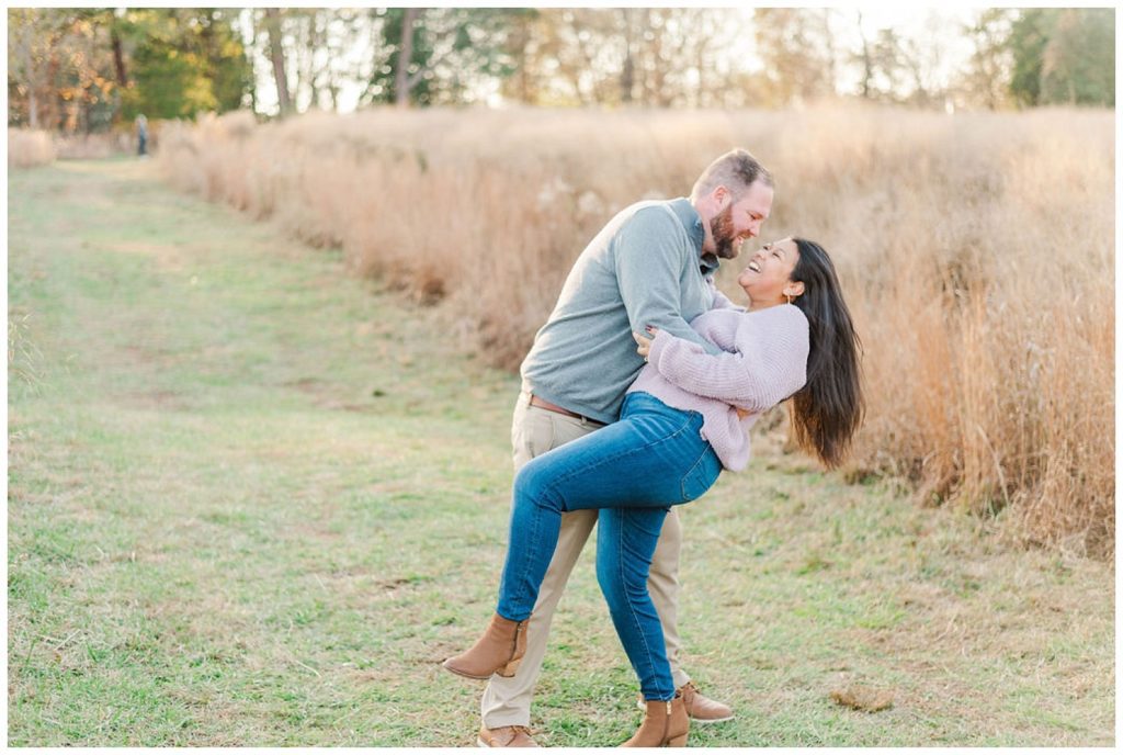 man dipping back his fiance at fall engagement session in Winston-Salem, NC