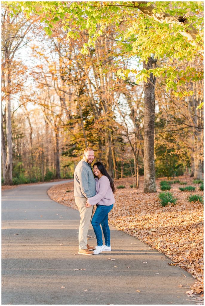 engaged couple standing in the road at Reynolda fall photo session