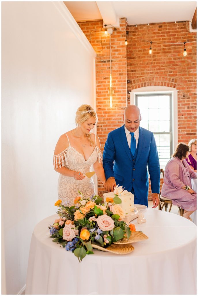 bride and groom cutting cake at the River Room in Wilmington, N.C.