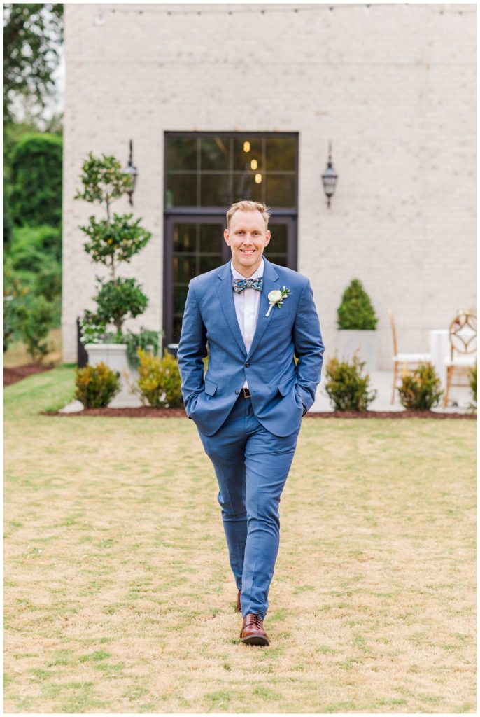 groom walking on the lawn at The Maxwell wedding venue