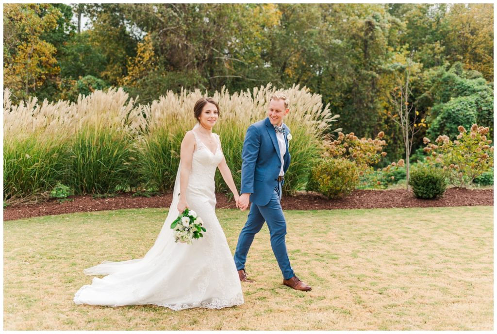 bride and groom walking on the lawn at Raleigh NC wedding venue