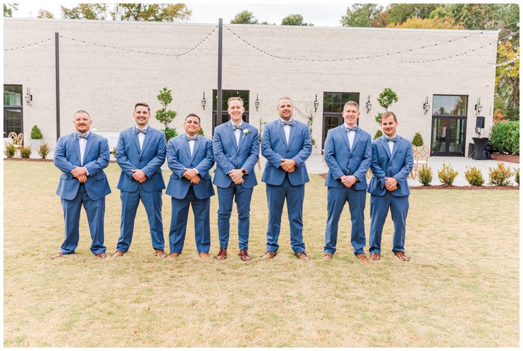 groomsmen posing on the lawn for fall wedding in Raleigh