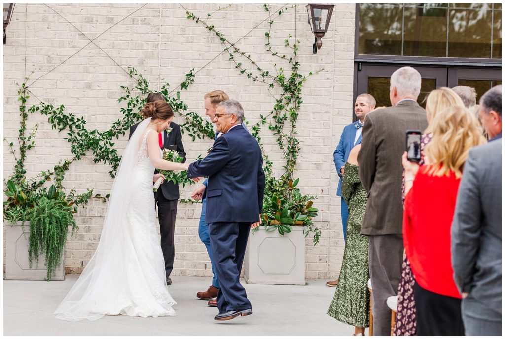 bride's dad giving her away at wedding ceremony