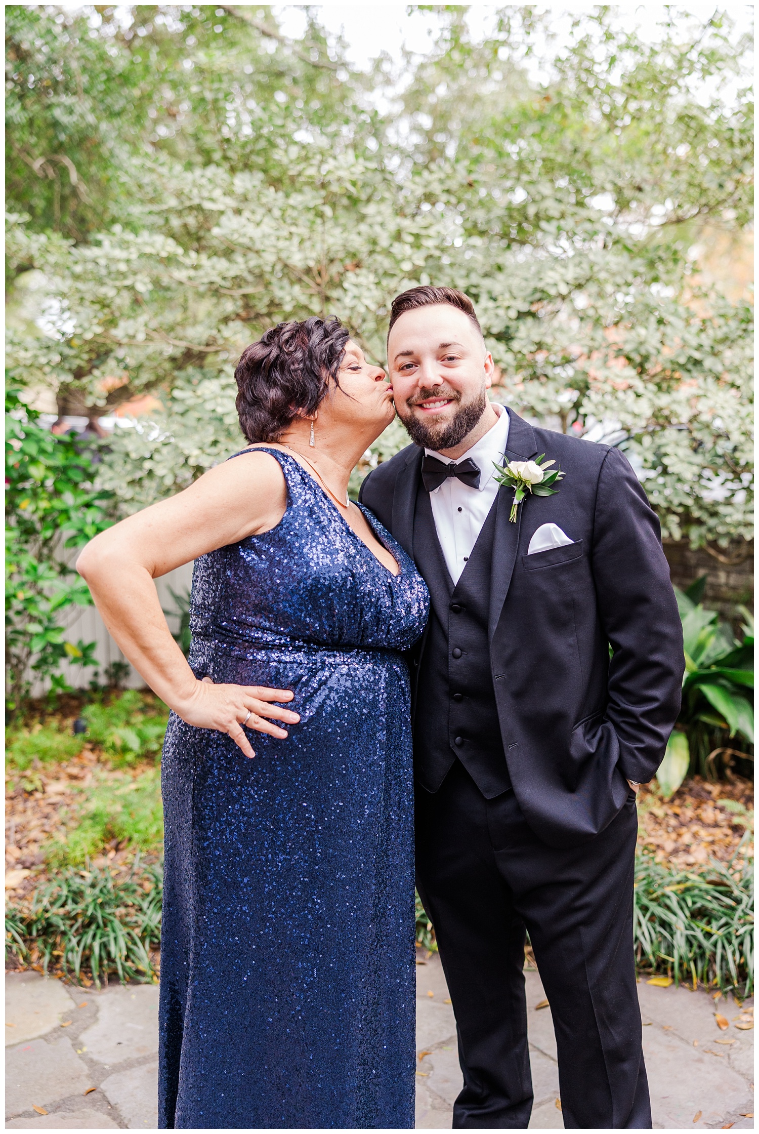 groom's mom kissing the groom before wedding in Wilmington, NC