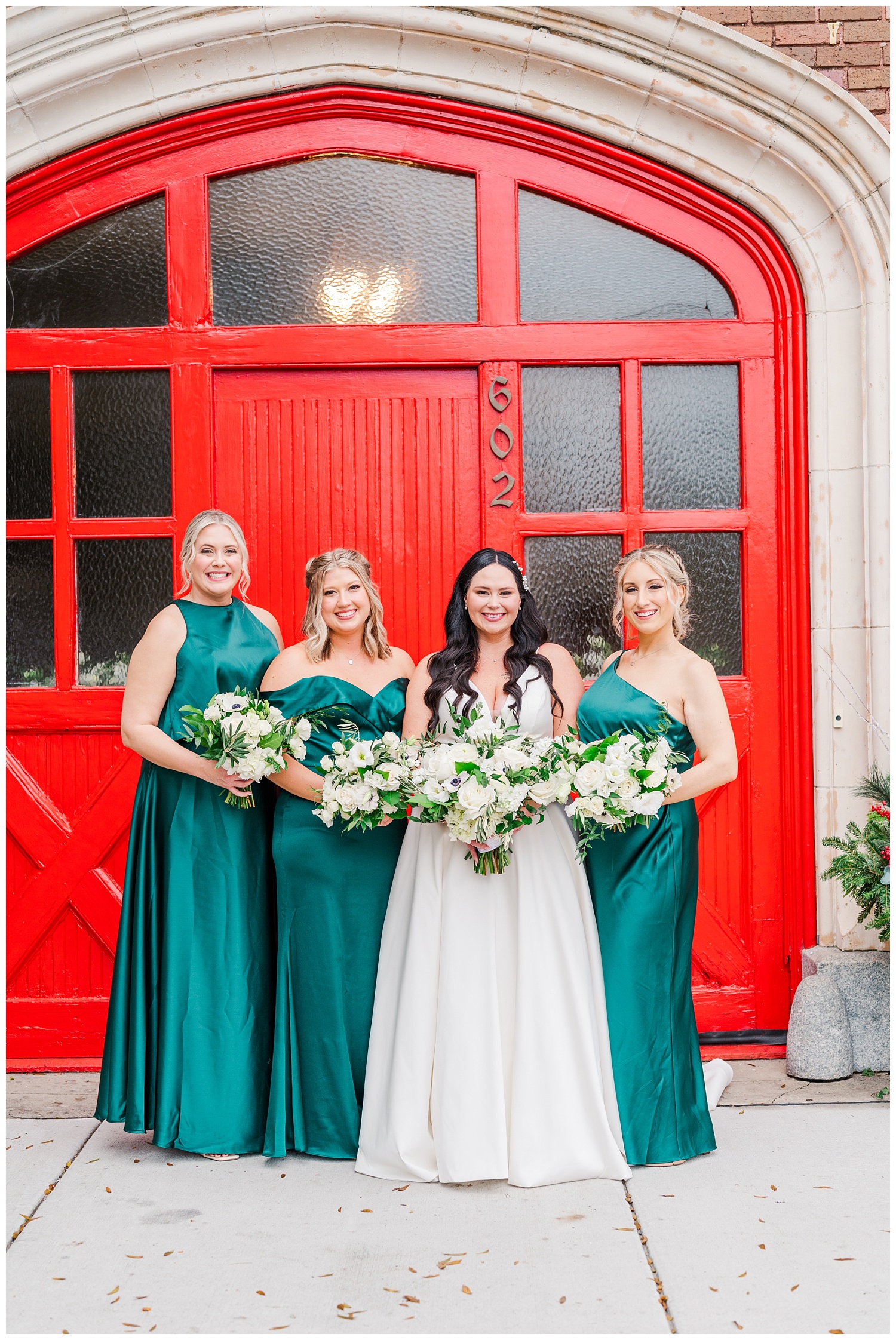 bridal party posing in green dresses at Station No.2