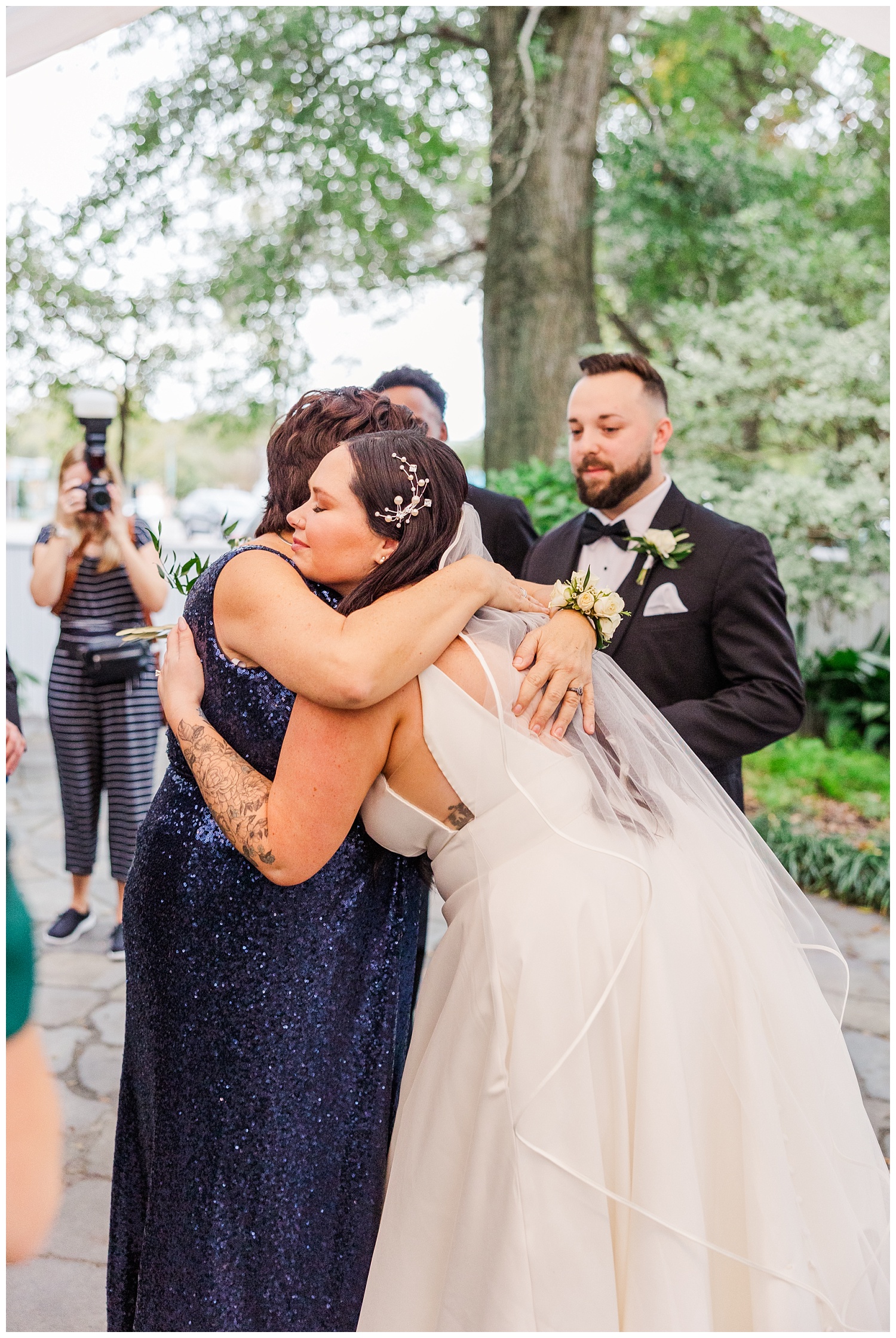 bride hugging mom of groom during cocktail hour in Wilmington